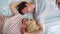 Top view portrait of young lovers lying in bed face to face bonding