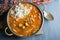 Top view of a pot of gumbo and scoop of white rice, made with okra, sausage and chicken.