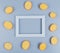 top view of potato slices around frame on blue background with copy space