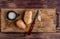 top view of potatoes salt knife on cutting board on wooden background