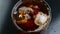 Top of view pouring of fresh coke in the drink glass with ice cubes on black background, fun and summer time