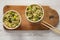 Top view, prepared instant noodles with beef flavoring in cups over white wooden background. Flat lay, from above, overhead