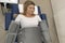 Top view pressure therapy procedure. Woman lying in massaging suit in hospital, treatment