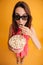 Top view of pretty young woman in 3d glasses eating popcorn, loo