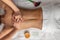 Top view professional masseuse performing with hands back massage to young woman client in wellness spa center. Beauty photo and