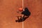 Top view of a professional tennis player serves the tennis ball on the court with precision and power