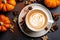 Top view of pumpkin latte accompanied by a charming fall-themed arrangement. Vibrant orangery pumpkins and seasonal accents