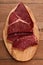 Top view of raw black angus beef on a wood board.