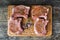 Top view of raw fresh pork ribs with spices. Raw fresh meat steak and meat cleaver on dark background