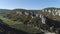 Top view of recreation center in valley of rock mountains. Shot. Panorama of valley of gorge rocky ledges with gardens
