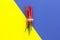 Top view, red chili pepper, tied with braid on a yellow-blue background, vertically arranged