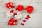 Top view on red hearts laying near word LOVE written by wooden letters on white background