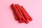 Top view of the red licorice sticks on a pink background