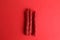 Top view of the red licorice sticks on a red background
