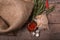 Top view of red spicy chili pepper in a glass jar, shucks of quail eggs and twigs of rosemary on a wooden background.