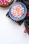 Top view of red and white tangyuan in blue bowl on white background for Winter solstice