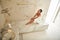 Top view of relaxed lady touching her neck while being in hammam