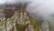 Top view on relief of rocks autumn in fog. Shot. View of rock formations of mountain with colored dry grass and shrubs