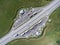 Top view at resting area of tollway with parked freight long vehicles and passenger cars, a cafe and toilets