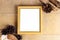 Top view of retro empty photo frame with natural decorations, branches and cones on wooden background as a mock up