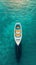 Top view of a retro fishing boat in blue clear ocean. Shade from the sun's rays. Ocean still life concept