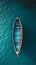 Top view of a retro fishing boat in blue clear ocean. Shade from the sun's rays. Ocean still life concept