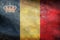 Top view of retro flag Belgium with crown, Belgium with grunge texture. Belgian patriot and travel concept. no flagpole. Plane