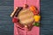 top view of ripe organic vegetables and pepper grinders around wooden board on table