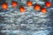 Top view of ripe persimmons on wooden rustic table