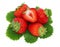 Top view of ripe strawberries pile with green leaves (isolated)