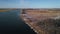 Top view of river and yellow field with snow. Clip. Beautiful natural panorama of river and fields in spring. Wide river