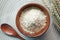 top view of roasted oats flakes in a wooden bowl on table