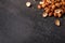 Top view of roasted peeled hazelnuts on a saturated black background. Savory bright snacks. Copy space.