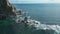 Top view of rocks in sea with abandoned lighthouse. Clip. Beautiful view of old lighthouse and rocky cape in sea