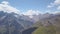 Top view of rocky mountains with patches of snow. Clip. Beautiful panorama of mountains with rocky peaks and snow in