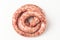 Top view on a rolled beef sausage on white background