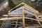 Top view of roof frame from wooden lumber beams and planks on walls made of hollow foam insulation blocks. Building, roofing,