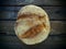 top view of round bread. Delicious fresh cornbread with sprinkles on an old wooden table. Copy space. Traditional