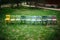 top view of a row of colorful, rainbow-colored chairs standing in a line on the lawn in the backyard for a cozy wedding