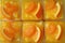 Top View of Rowed up Mandarin Orange Cakes Topped with Fresh Oranges in Glass Bowls