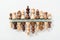 Top view of rows made of wooden chess figures on white background .