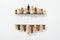Top view of rows made of wooden chess figures on white background with copy space.