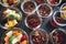 Top view of rows of transparent glass dishes with fruit salad and chocolate dessert. Celebration, party, birthday or