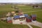 Top view of rural landscape on sunny spring day. Farm with solar photo voltaic panels system on wooden building, barn or house