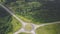 Top view of rural roundabout. Clip. Traffic on roundabout rural road in wooded area