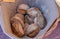 Top view on rustic bread in a wooden wicker basket on a natural linen napkin