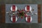 top view of rustic table setting with red tulips bouquet, tarnished cutlery, wine glasses, candles and empty plates on tabletop