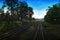 Top view of the rusty rails crossing the green field in a summer day , Northern Railway Thailand