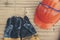 Top view of Safety helmet hard hat and glove for engineer, safety officer or architect, place on old wooden floor. Orange safety