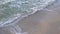 Top view of a sandy beach, sea waves crashing on the shore, sea foam.Beautiful soothing video, relaxation.Sea landscape, storming